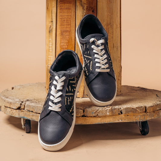 Lowtop mudcloth sneaker in black milled leather and royal soles.